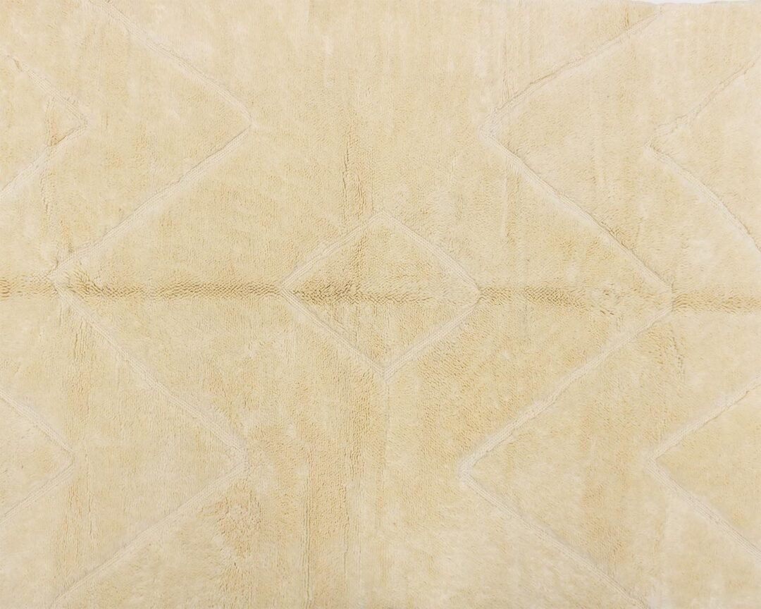 A close-up of a beige textured carpet showcases a subtle geometric diamond pattern, blending elegance with modern design.