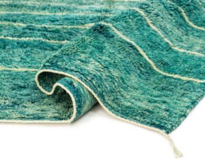 A green rug with a wavy pattern, partially rolled at one corner, showcases a fluffy surface that resembles ocean waves.