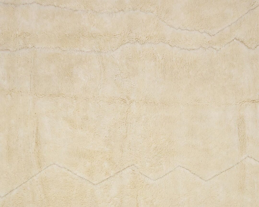 A close-up view of a beige textured fabric featuring subtle zigzag patterns, creating an intricate design across the surface.