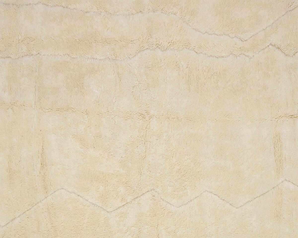 A close-up view of a beige textured fabric featuring subtle zigzag patterns, creating an intricate design across the surface.