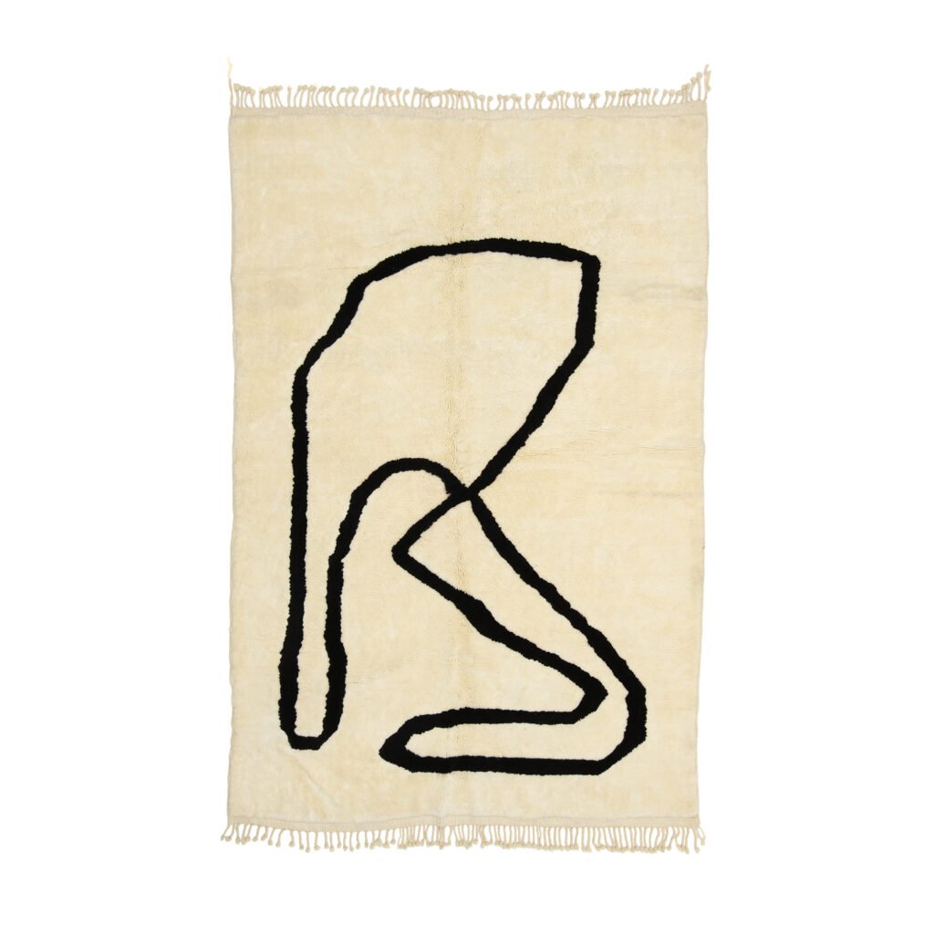 This beige hand-knotted rug features fringed edges and a black abstract line design of loops and curves, reminiscent of a Moroccan style.