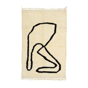 This beige hand-knotted rug features fringed edges and a black abstract line design of loops and curves, reminiscent of a Moroccan style.