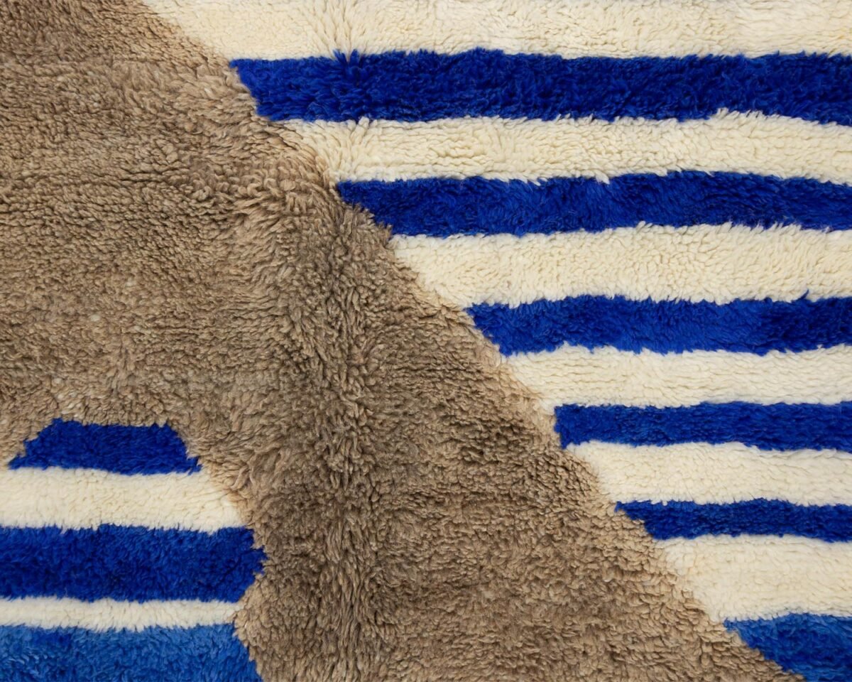 Close-up of a surface with alternating blue and white stripes and a contrasting brown section.