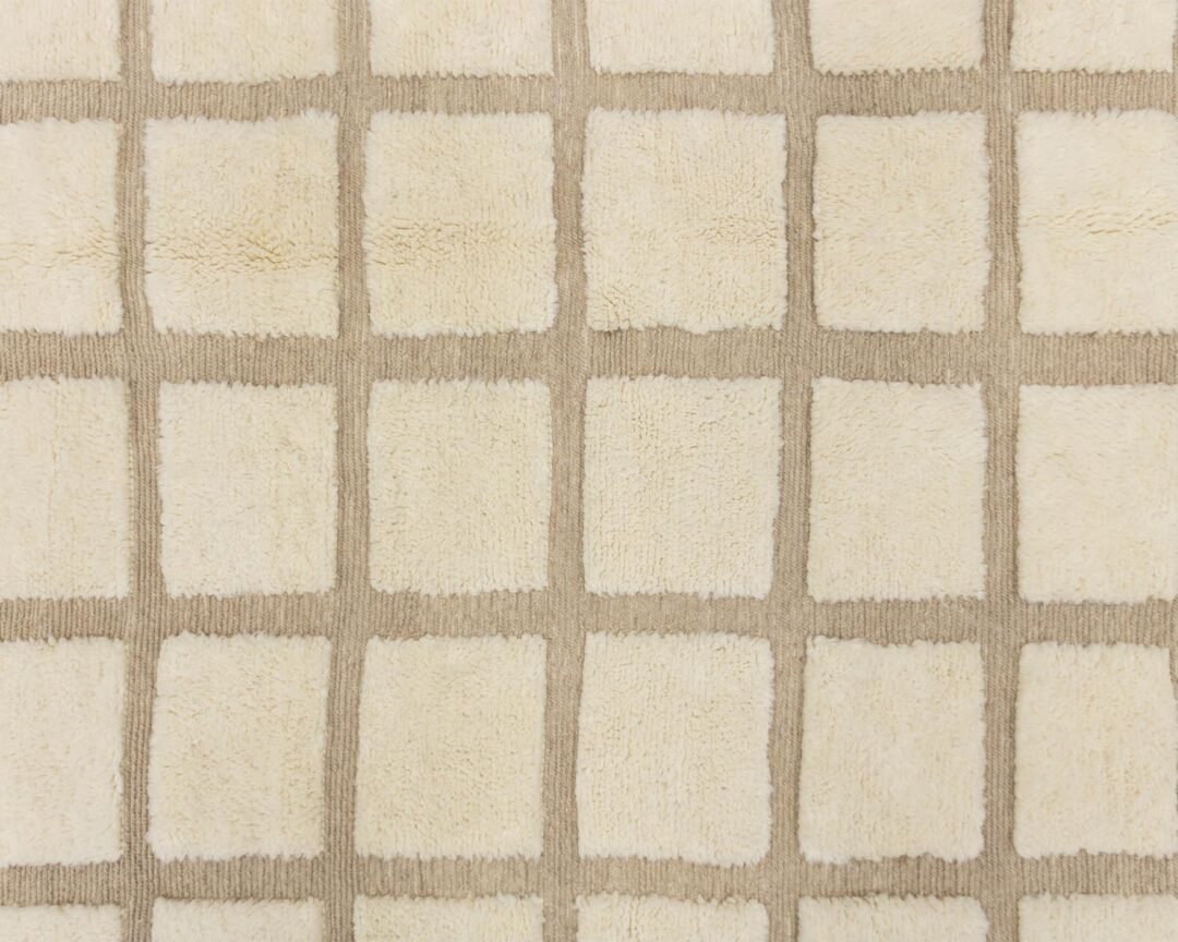 A beige and cream checkerboard pattern adorns the textured surface, exuding elegance and simplicity.