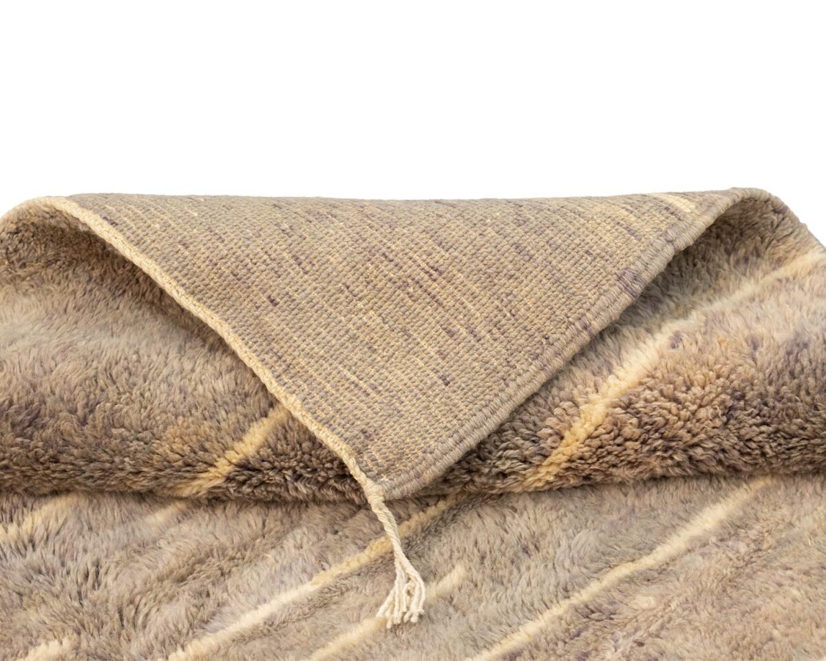 A folded fuzzy fabric with a visible corner showcases dual textures: a smooth outer surface and a soft, fluffy inner side.