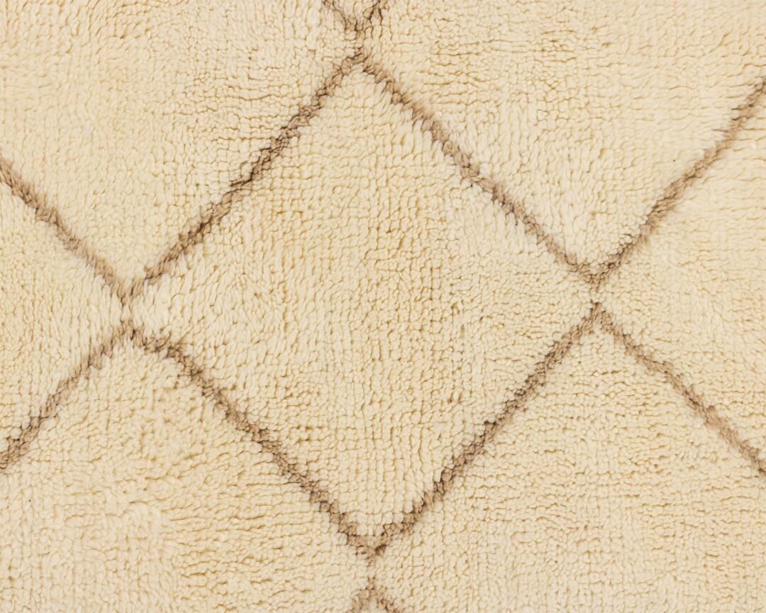 Close-up of a beige textured material featuring a diamond pattern created by intersecting dark lines. The intricate design adds an elegant touch to the fabric, making it suitable for various home decor applications.