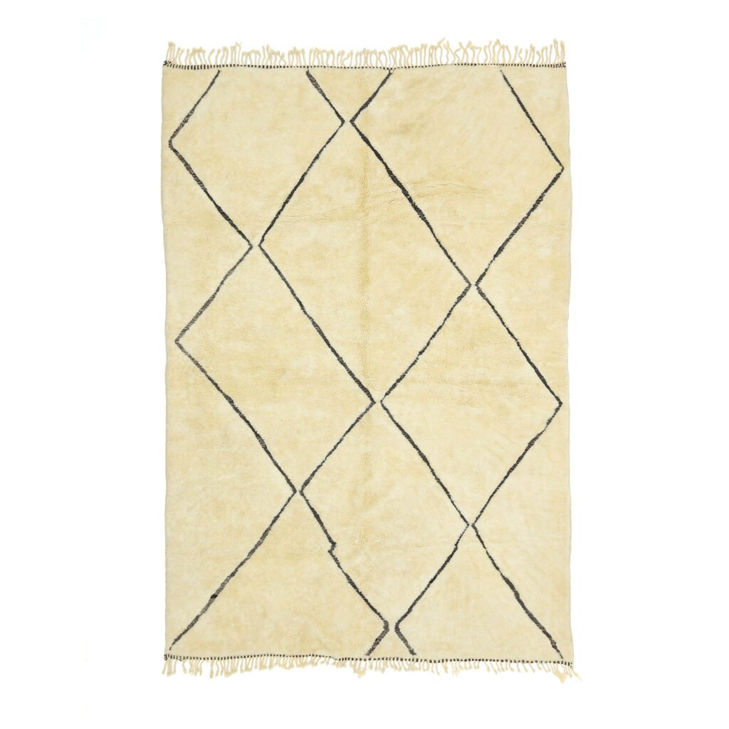 Cream-colored rug with a diamond pattern created by thin black lines and fringed edges, making it an elegant addition to any room.