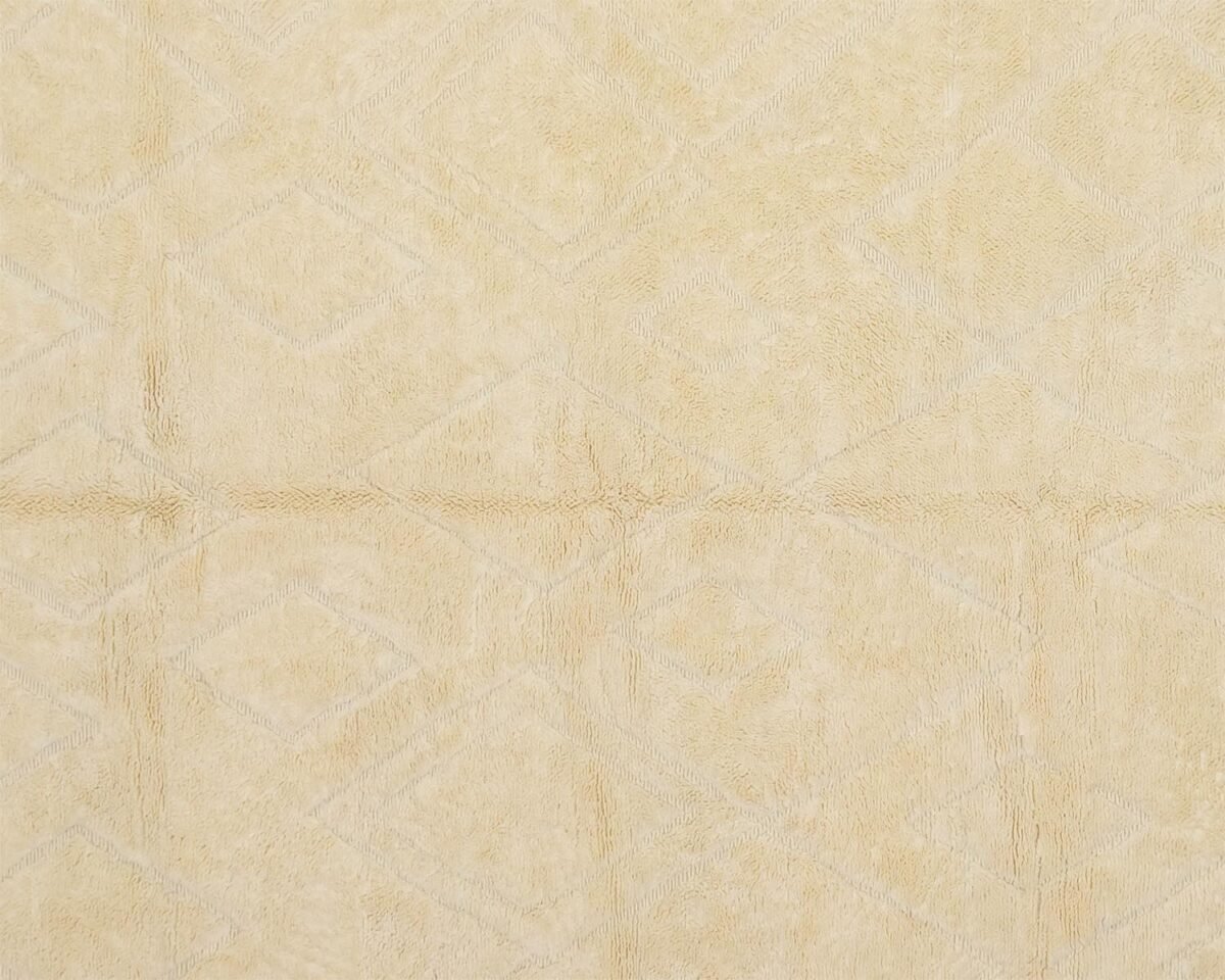 Close-up of an artisanal rug, showcasing a beige fabric with a subtle diamond pattern.