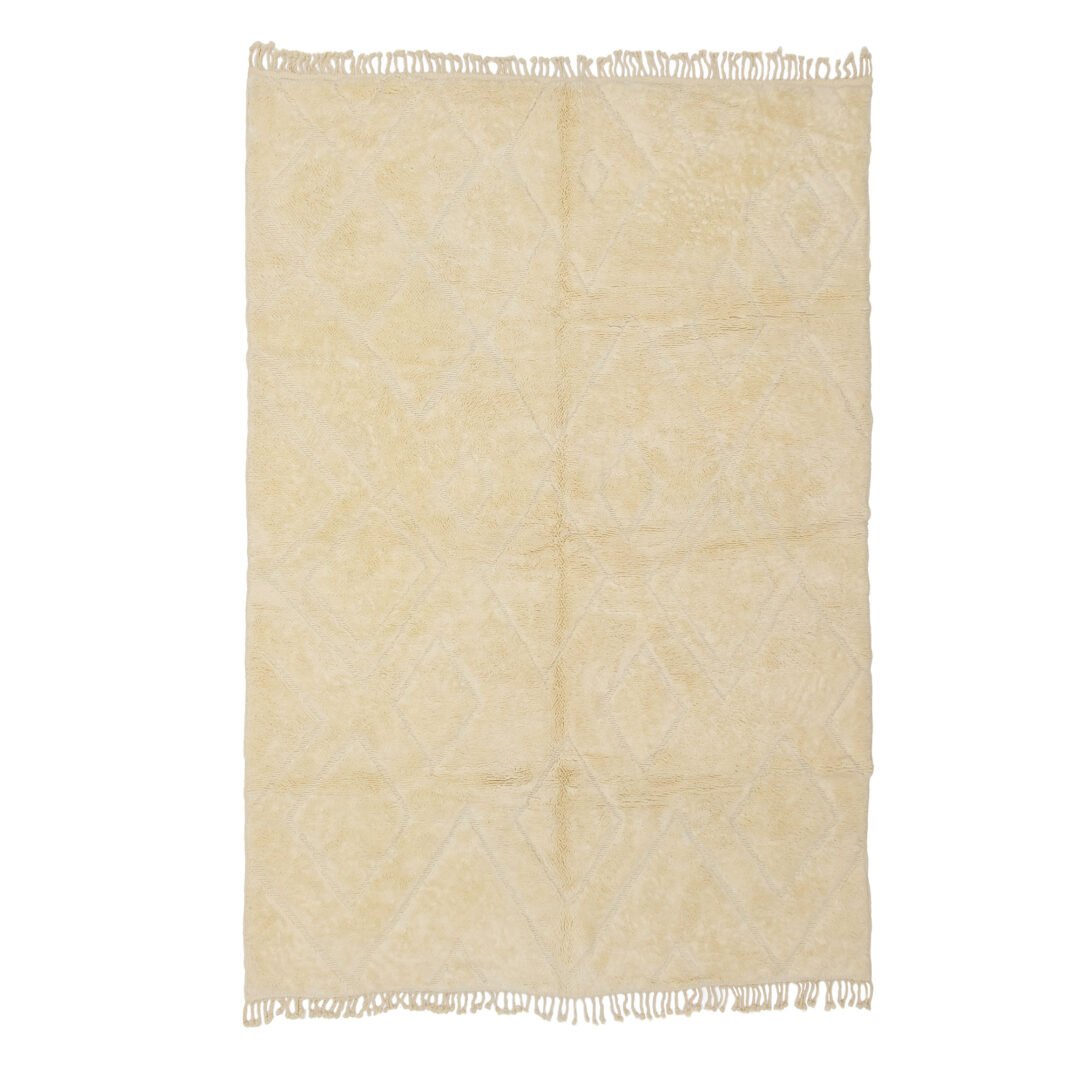 This beige rug features a subtle diamond pattern and elegant fringed edges, perfect for adding warmth and style to your living space.