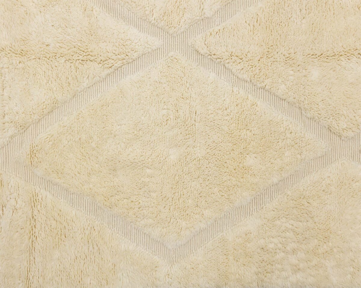 Diamond-patterned beige carpet featuring subtle, lighter lines creates an elegant look.