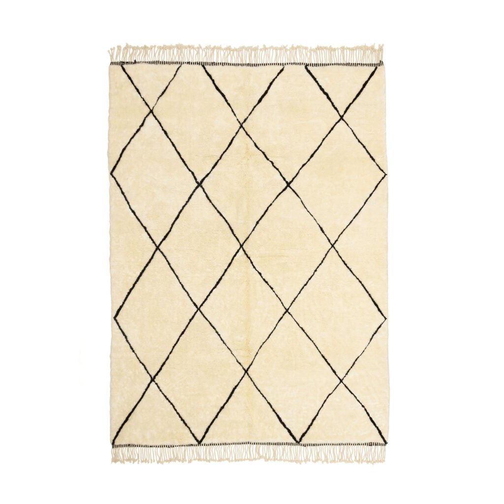 A rectangular beige Moroccan rug showcases a black diamond pattern and fringed edges, adding a touch of elegance to your space.