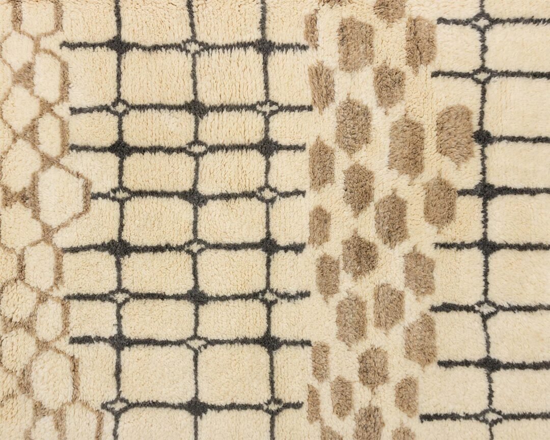 Close-up of a beige carpet showcasing two distinct patterns: elegant hexagonal shapes on the left in rich dark brown and black, contrasting with a harmonious blend of similar brown hexagons on the right.