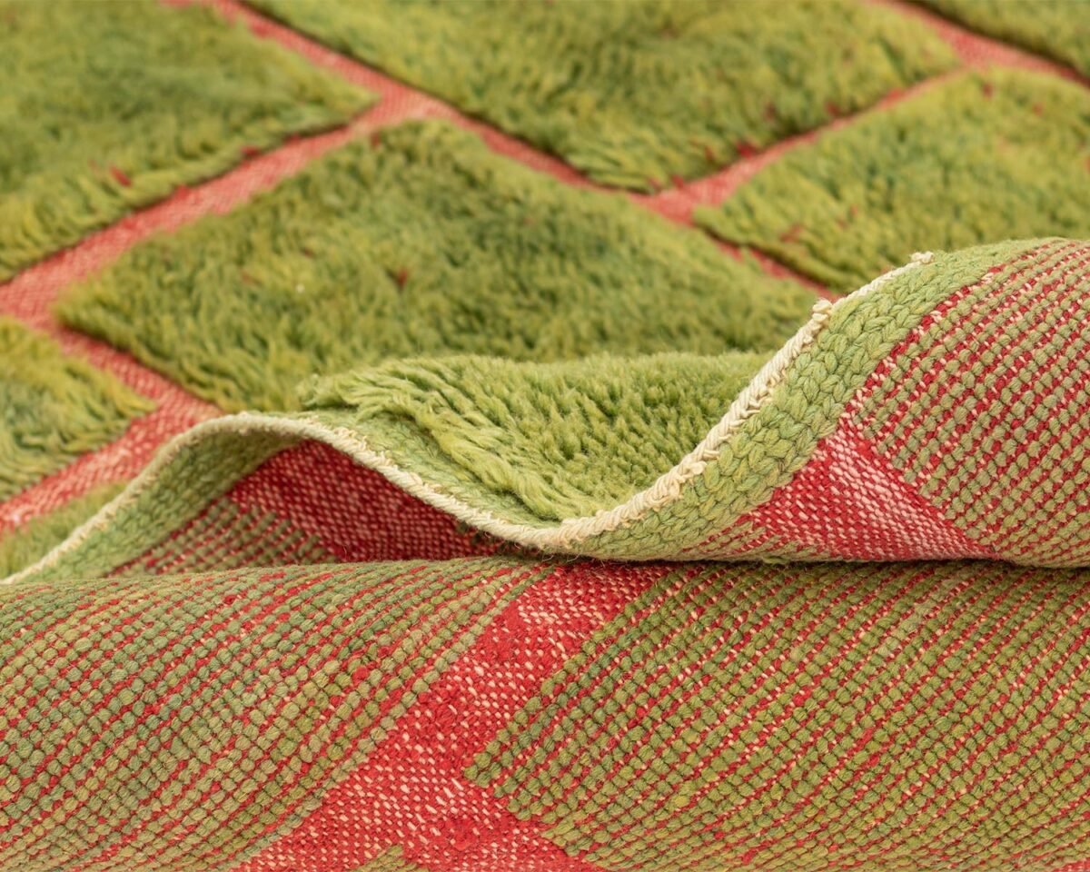 Green Moroccan rug with a textured brick pattern in contrasting red, back and side focus detail