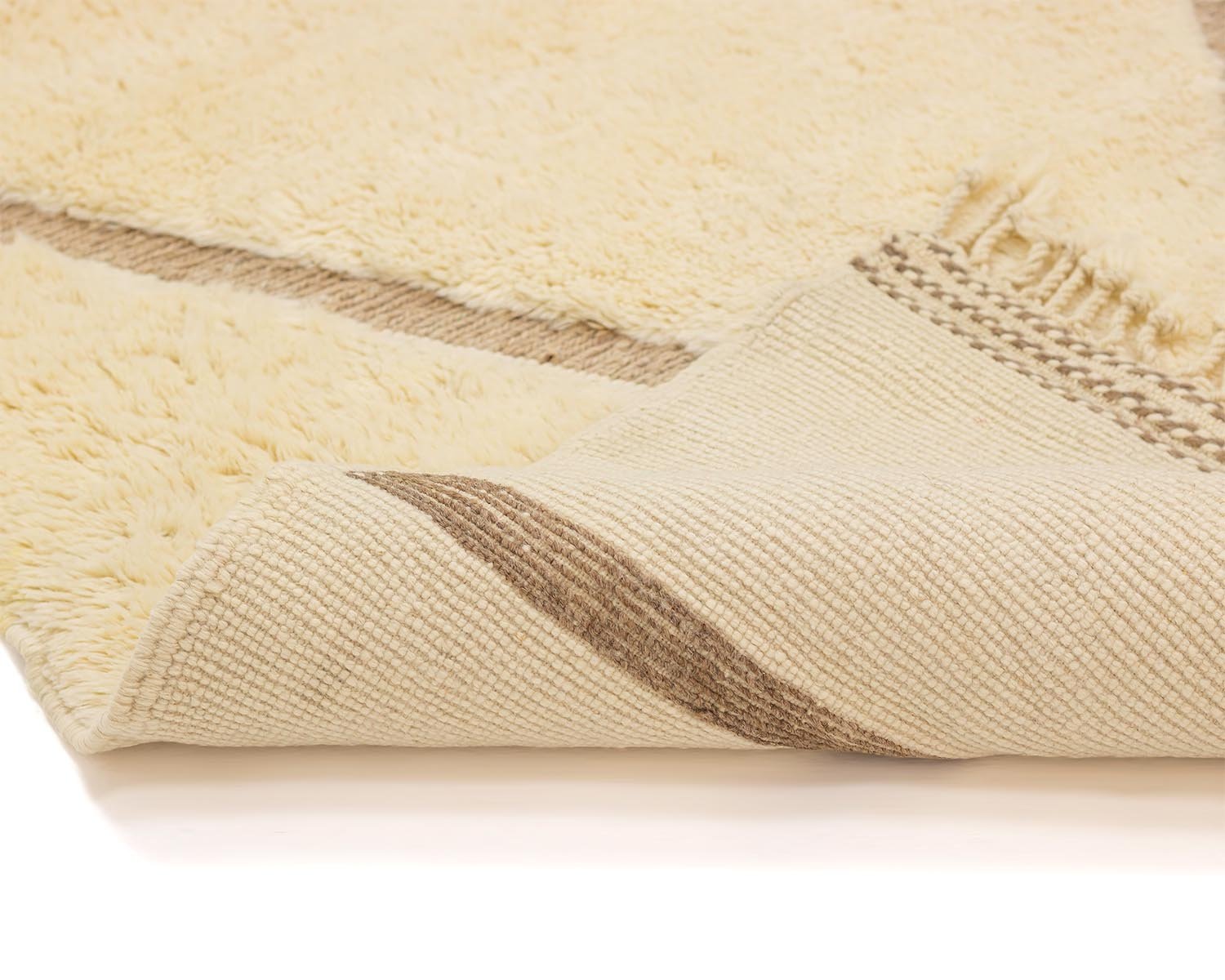 Close-up of a beige woven rug with a brown striped pattern, elegantly revealing its textured underside.