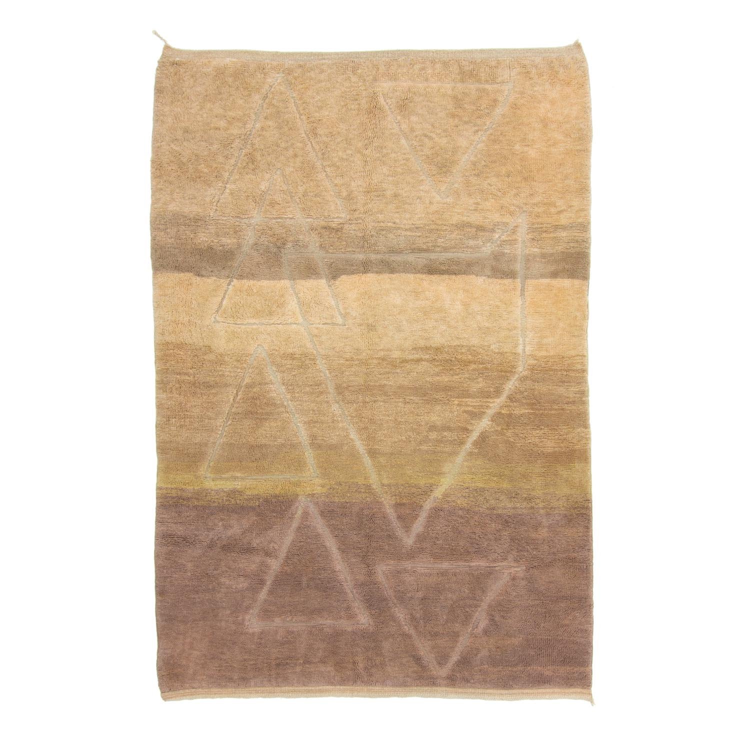 This hand-knotted rug features earthy tones and subtle triangular patterns in shades of beige, brown, and tan. Its luxurious design adds an elegant touch to any room, reflecting the timeless artistry of Moroccan rugs.