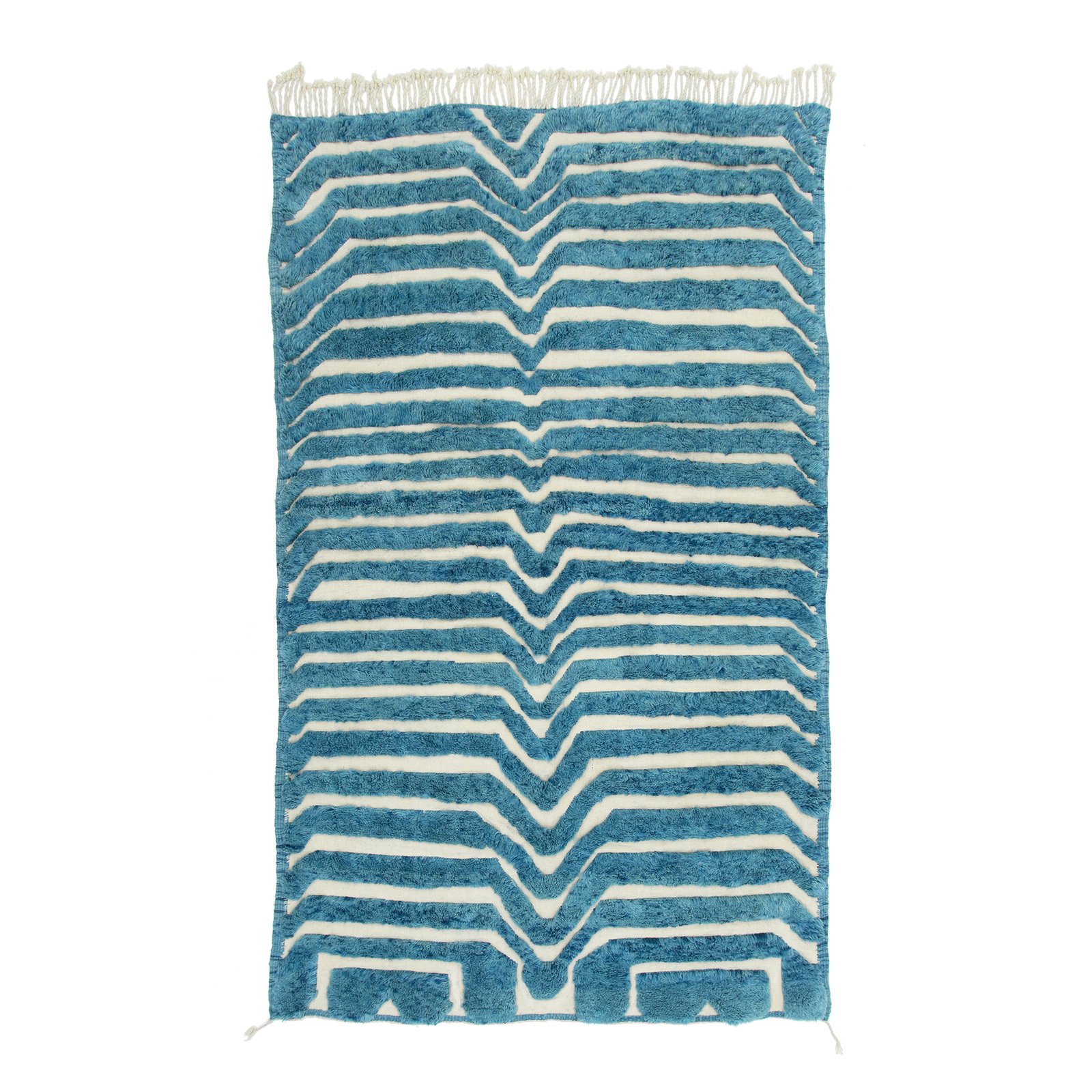 Handwoven Moroccan rug featuring bold zigzag patterns in shades of blue and white, with fringed edges, perfect for adding a touch of elegance to any room.