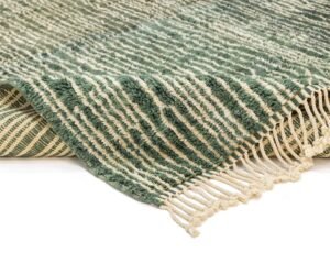This close-up showcases a hand-knotted rug in green and cream, featuring an elegant striped pattern and fringe. The visible texture highlights the craftsmanship of this piece, making it a beautiful addition to any handmade home decor collection.