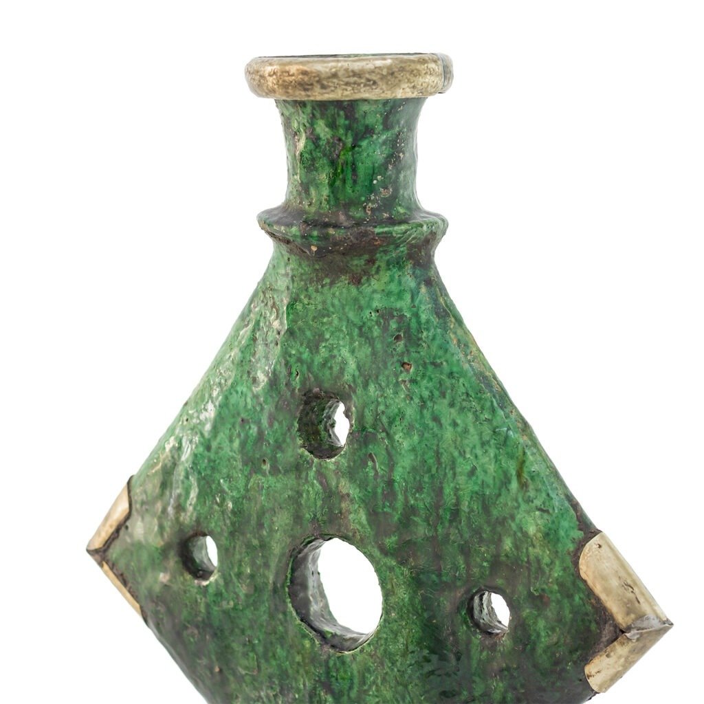 This green, diamond-shaped ceramic vase reflects the essence of Tamegroute pottery, with its narrow neck, circular holes, and a beautifully textured surface.