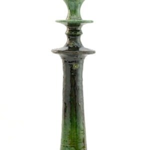 Tall, glossy green ceramic candlestick reminiscent of Tamegroute pottery, with a textured surface. It features a wide base and narrow top for holding a candle, displayed against a plain white background.