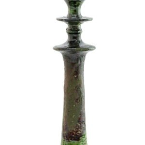 The tall green ceramic vase, inspired by Tamegroute pottery, showcases a textured surface and layered design, featuring a narrow neck and flared top.