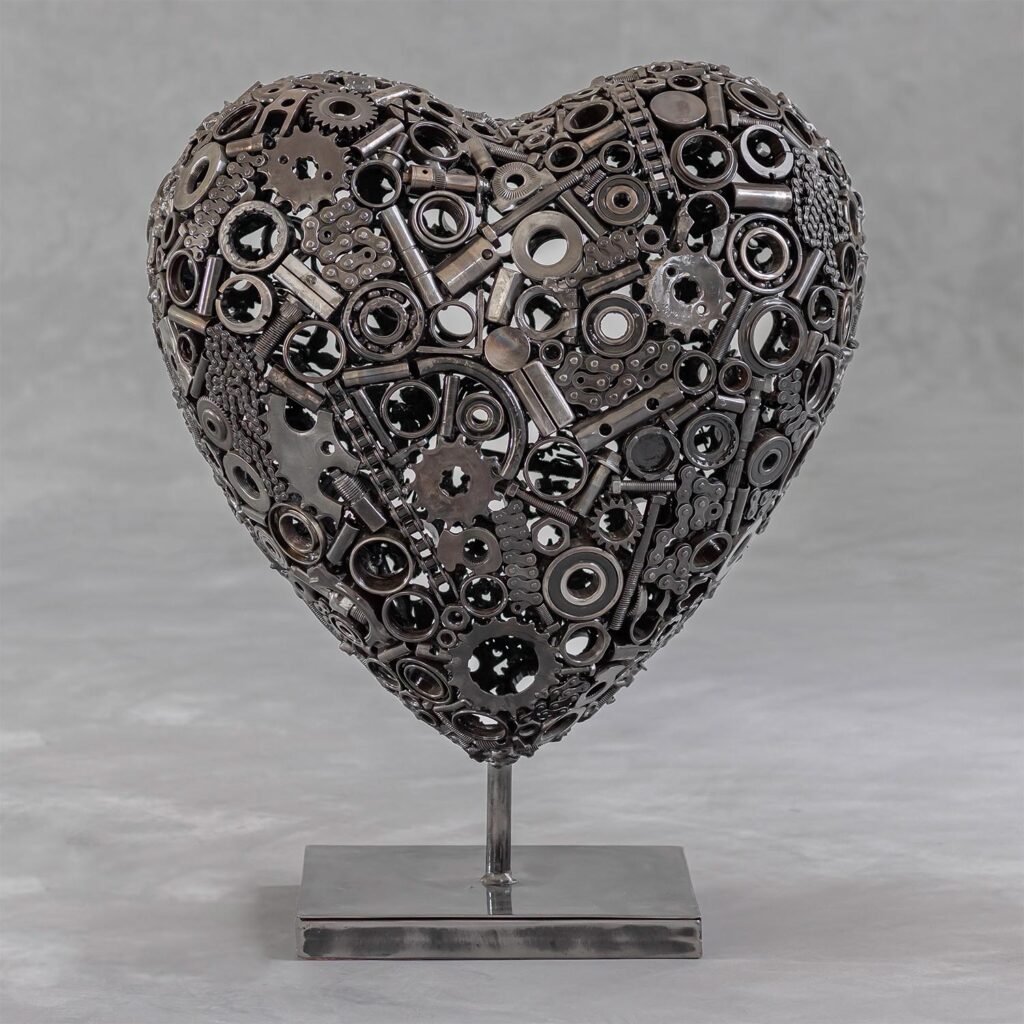 A heart-shaped metal gears sculpture crafted with intricate mechanical parts, proudly mounted on a sleek rectangular base.