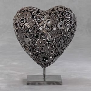 A heart-shaped metal gears sculpture crafted with intricate mechanical parts, proudly mounted on a sleek rectangular base.