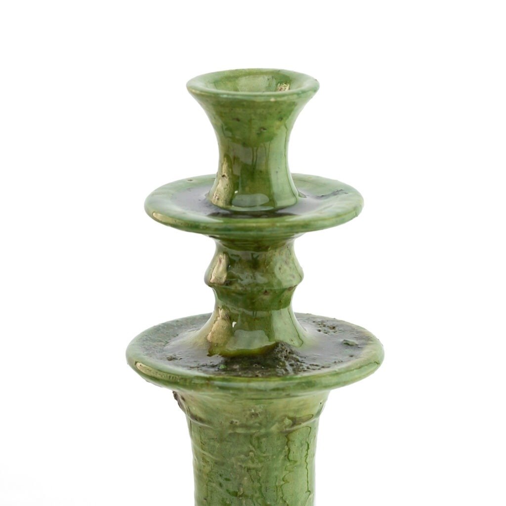 This green ceramic candle holder, inspired by Tamegroute pottery, features a wavy surface and two wide rims, elegantly designed to hold a single candle.