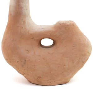 An unglazed Tamegroute pottery piece, this clay sculpture boasts an organic shape with a central hole. Its surface texture is rough and uneven, exuding a rustic charm with its light brown color.
