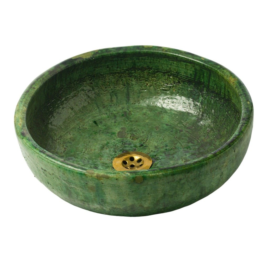 This exquisite sink features a round, green ceramic design reminiscent of Tamegroute pottery, with a shiny finish and a brass drain at the bottom.
