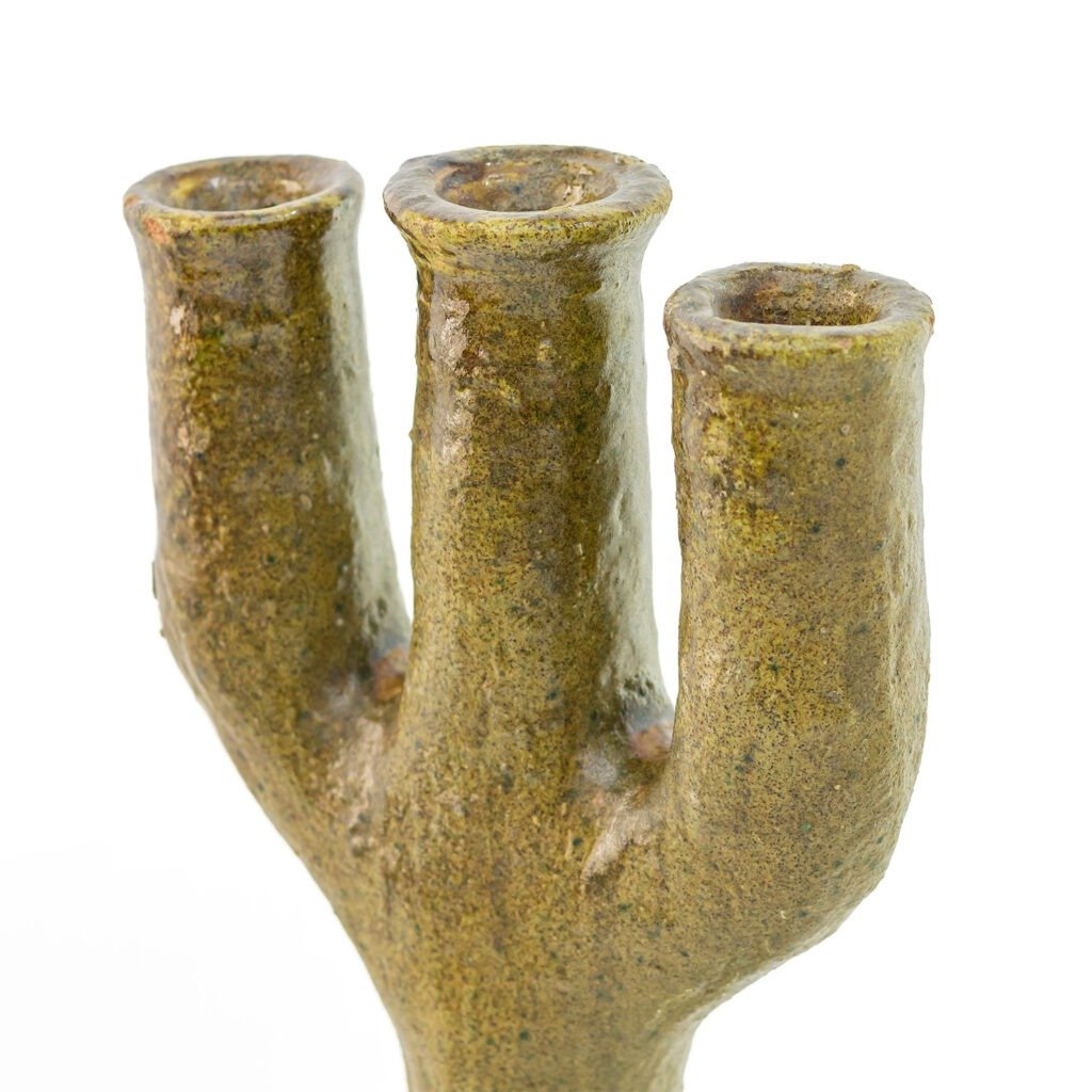 A ceramic vase with three elongated, cylindrical openings, resembling a tree branch, showcases the textured greenish-brown finish characteristic of Tamegroute pottery.