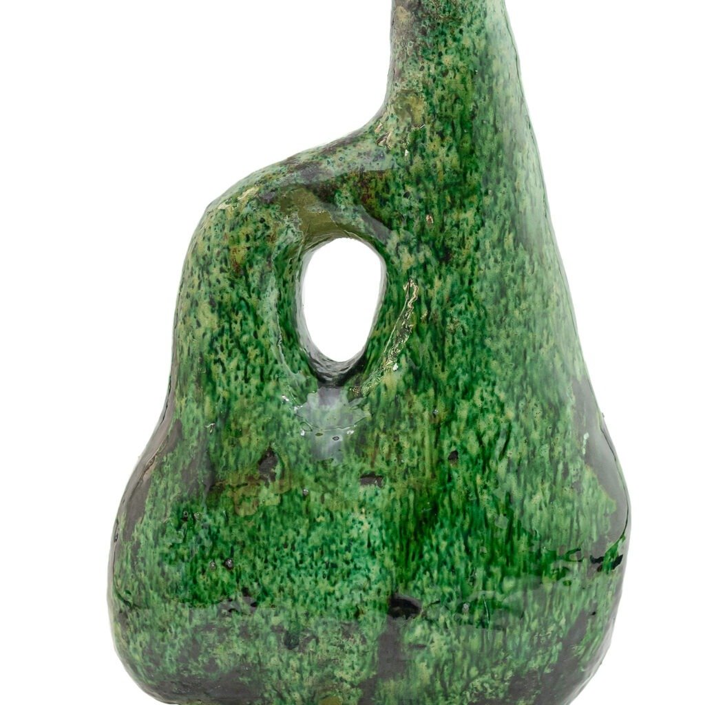 This green ceramic sculpture, reminiscent of Tamegroute pottery, boasts a textured surface with a smooth hole at its center.