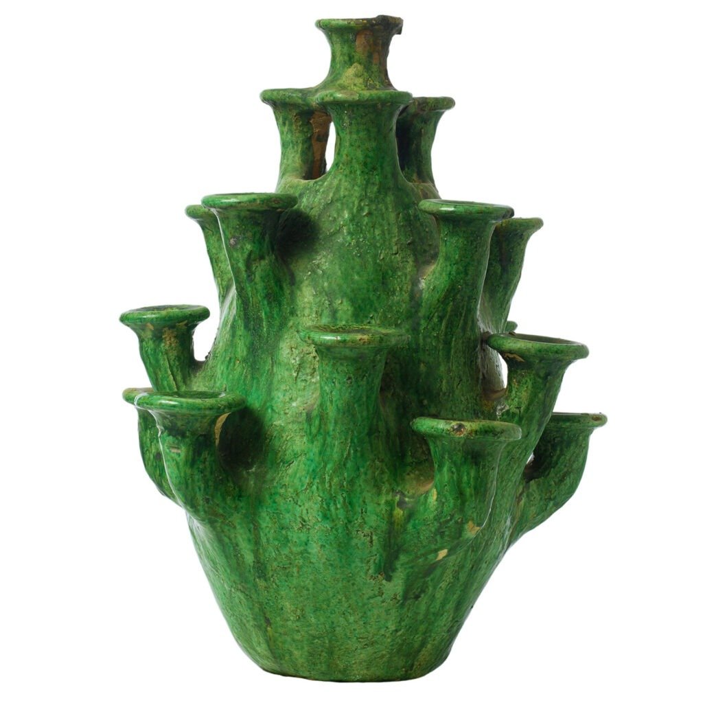 A tall, green ceramic vase crafted in the style of Tamegroute pottery, with multiple protruding spouts arranged in layers, resembling a tree or organic structure.
