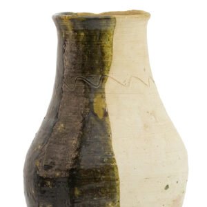 A ceramic vase inspired by Tamegroute pottery features a split design with glazed dark brown and plain beige sides, separated by an uneven wavy line.