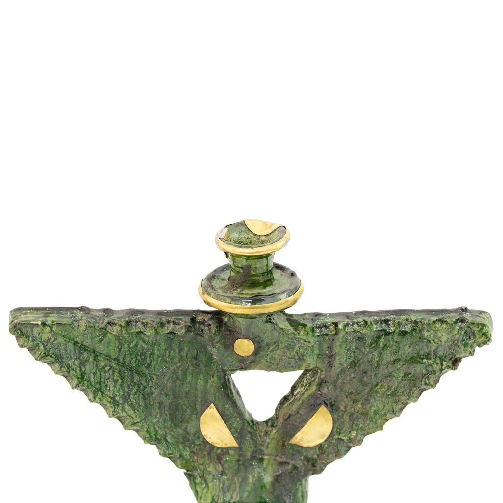 Green textured sculpture with gold accents, crafted in the style of Tamegroute pottery, features a symmetrical, abstract shape resembling two wings and a top hat.