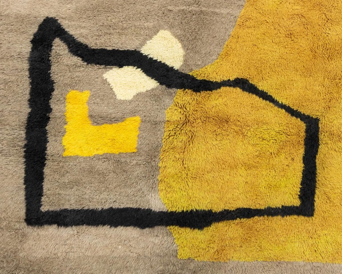 This luxury rug features an abstract geometric pattern with black outlines, complemented by areas of yellow, beige, and gray. Its sophisticated design effortlessly enhances any space, adding a touch of elegance to your home decor.