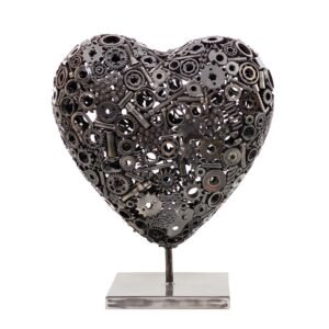 The Heart of Steel sculpture features a heart-shaped design crafted from metal gears and intricate mechanical parts, all mounted on a sleek rectangular base.