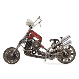 A unique scrap metal sculpture, this miniature motorcycle is crafted from various metal parts, showcasing a red frame, exhaust pipes, and a gear-like front wheel.