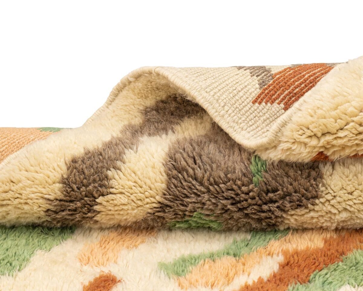 Experience the elegance of this hand-knotted plush rug, featuring a wavy pattern in shades of beige, brown, green, and orange. Perfect for adding a touch of luxury to any space.