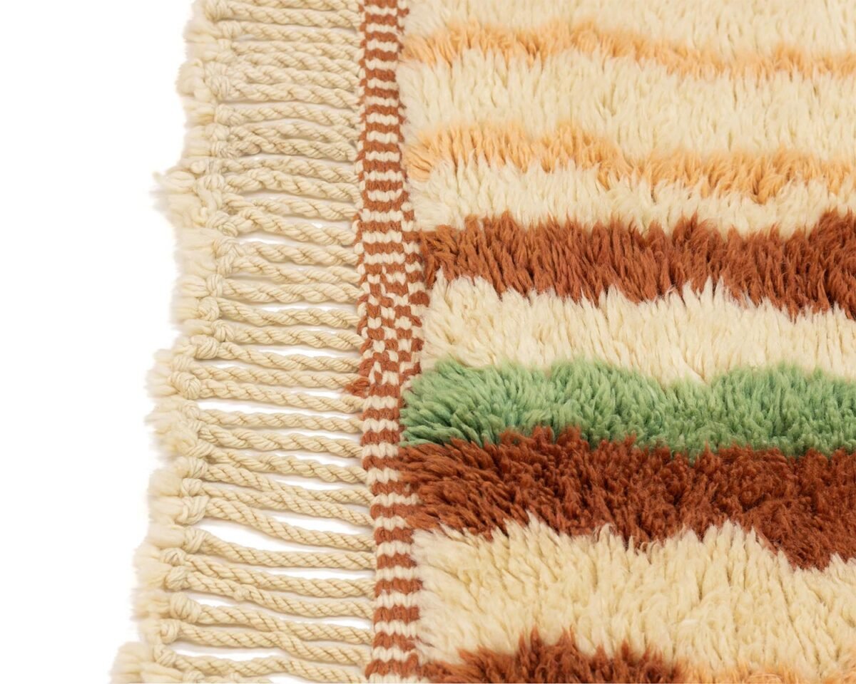 Experience the elegance of a hand-knotted rug with intricate fringed detailing and plush texture. This luxury piece features horizontal stripes in cream, brown, and green, adding an exquisite touch to any space.