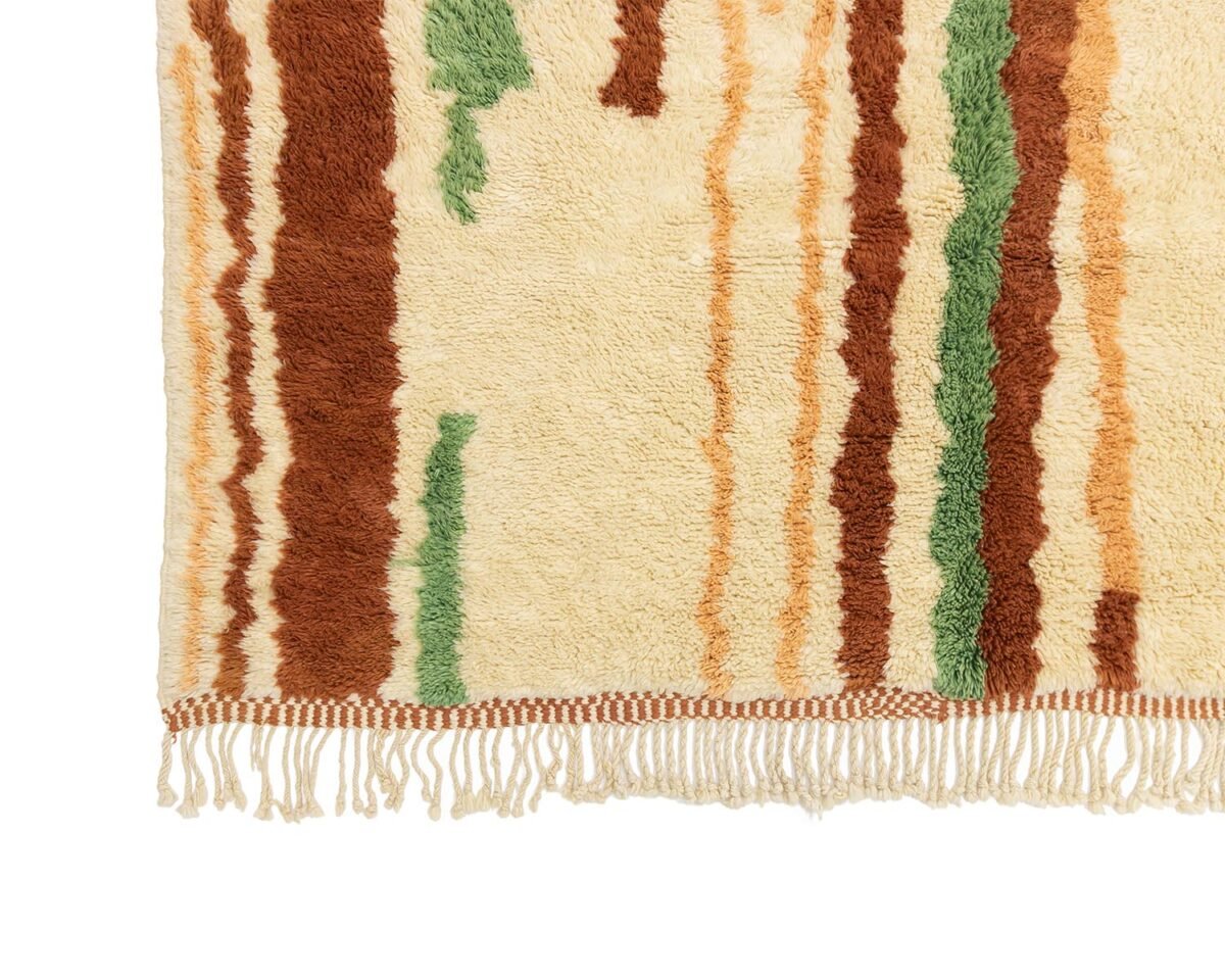 This luxurious woven rug corner features hand-knotted fringe, showcasing vertical stripes in brown, green, and beige on an off-white background.