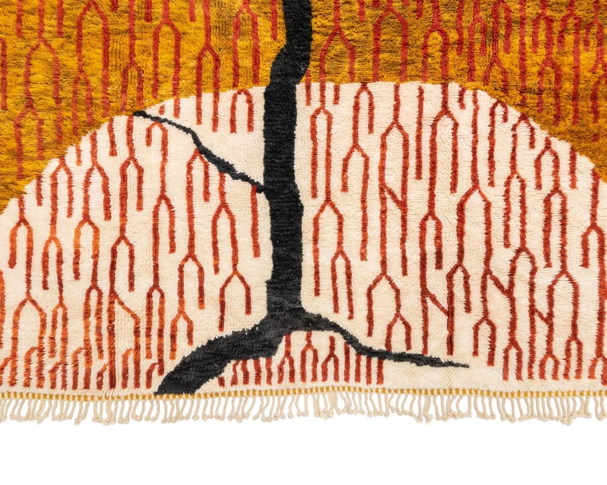 This luxury rug design showcases a tree-like pattern with a black trunk set against a beige backdrop, accented by intriguing red arches. The exquisite craftsmanship reflects its hand-knotted origins, making it an elegant piece of handmade home decor.