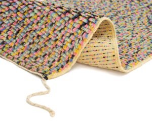 A vibrant woven rug features a folded corner, highlighting its rich texture and multicolored threads. From the edge, a loose yarn strand delicately extends, adding to the intricate detail.