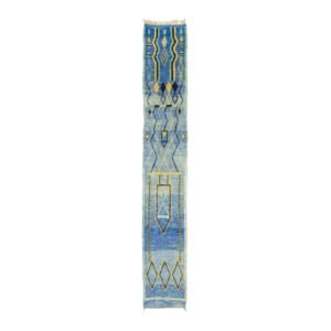 A blue and beige geometric patterned rug is elegantly featured against a plain white backdrop, adding a touch of modern sophistication to any space.