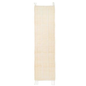A long, rectangular beige rug featuring a subtle square pattern and tassels at the corners is perfect for adding elegance to any room.