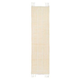 A long, narrow hand-knotted beige runner rug with a textured pattern. Fringes are visible at both ends.