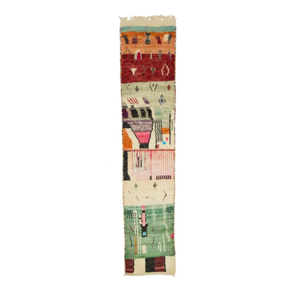 A vibrant tapestry showcases abstract geometric patterns on a slender strip of fabric, set against a white backdrop. Its multicolored design captures attention and adds artistic flair to any space.