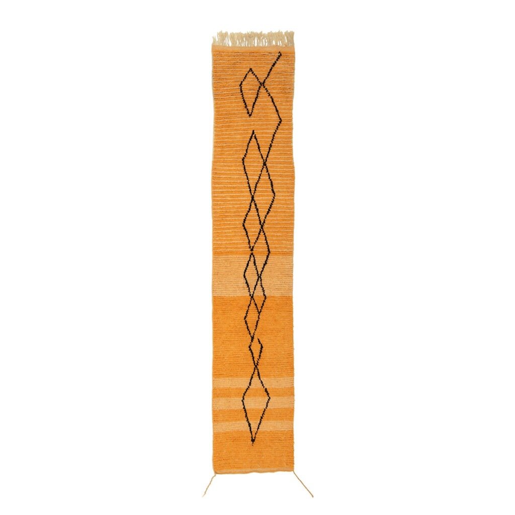 A vibrant orange runner rug adorned with a vertical geometric pattern of diamond shapes in the center.