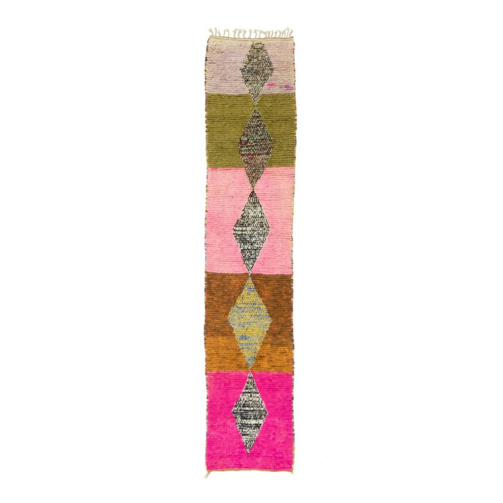 A vibrant woven rug showcases a vertical arrangement of six rectangular sections, each with a central diamond pattern. The bold palette of green, pink, orange, and beige adds a touch of elegance to any space.