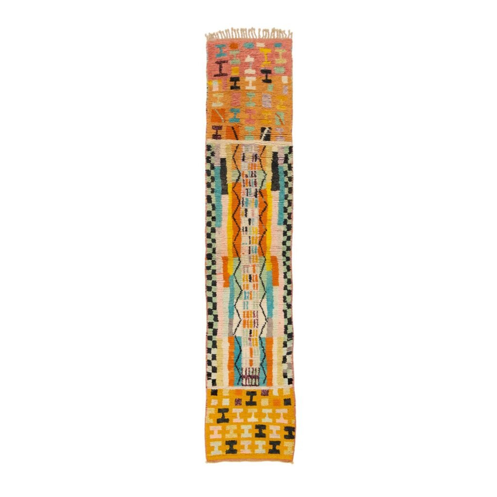 Vibrant geometric patterned runner rug with fringe on both ends, showcasing a blend of orange, green, blue, and beige tones.