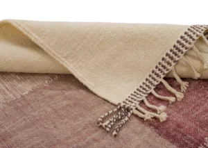 A handwoven textured beige and maroon rug with fringed ends and braided tassels.